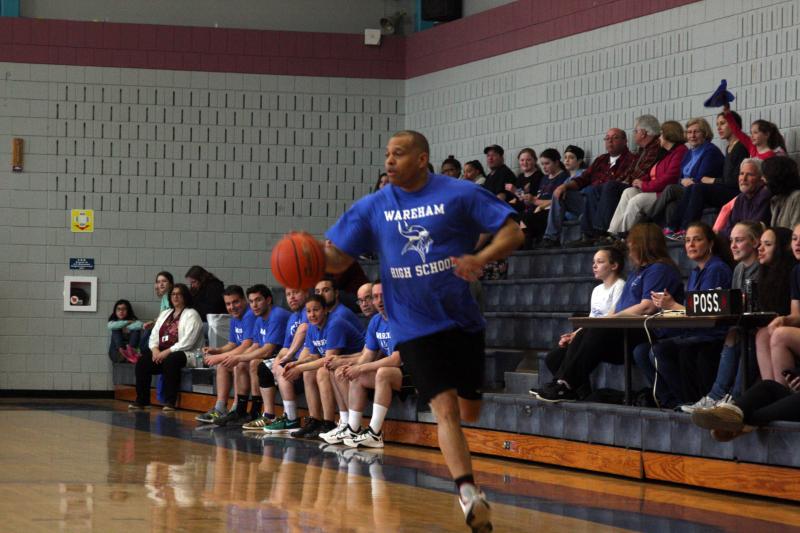 High school math teacher Paul Barnett drives up the court during the faculty fundraiser. BY MATTHEW BERNAT